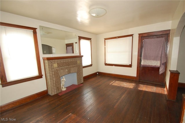 unfurnished living room featuring dark hardwood / wood-style floors and a fireplace