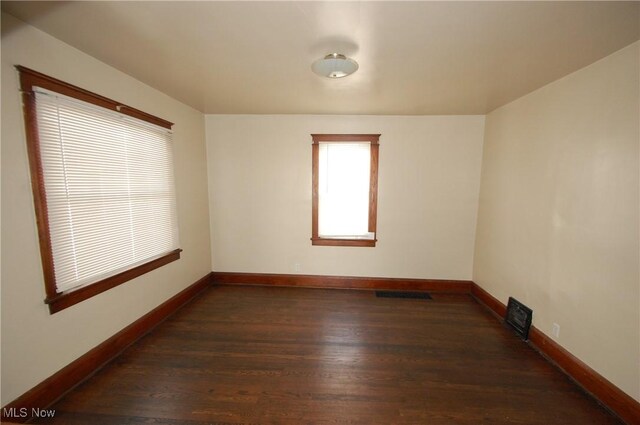 empty room featuring dark wood-type flooring