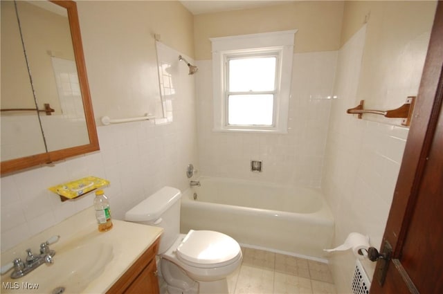 full bathroom with toilet, vanity, tile walls, and tiled shower / bath