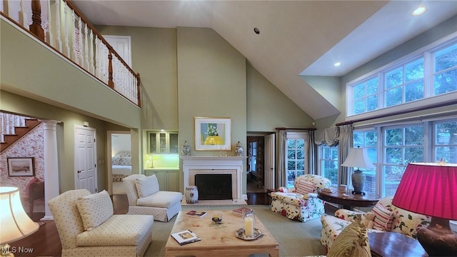 living room with high vaulted ceiling