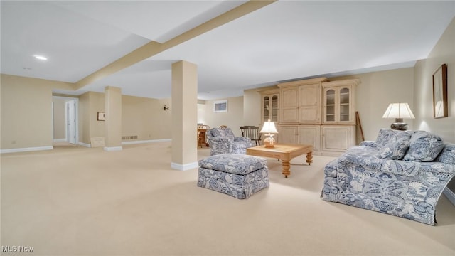 living room with visible vents, baseboards, and light carpet