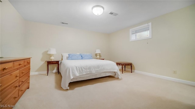 bedroom with light carpet, visible vents, and baseboards