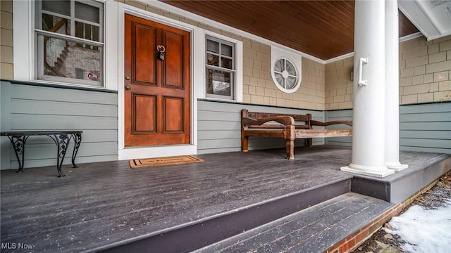 view of exterior entry with covered porch