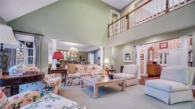 living room with high vaulted ceiling, decorative columns, and a chandelier