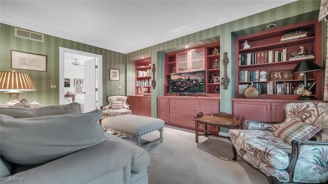 carpeted living area with visible vents and wallpapered walls