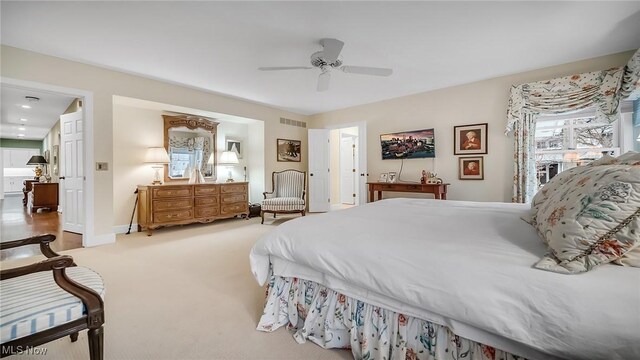 bedroom featuring a ceiling fan, visible vents, carpet floors, and baseboards