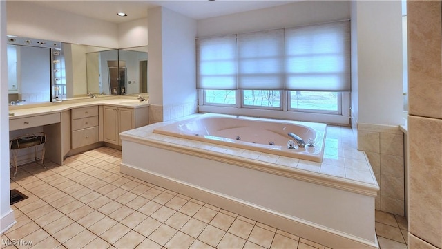 bathroom featuring vanity, tile patterned floors, and a whirlpool tub