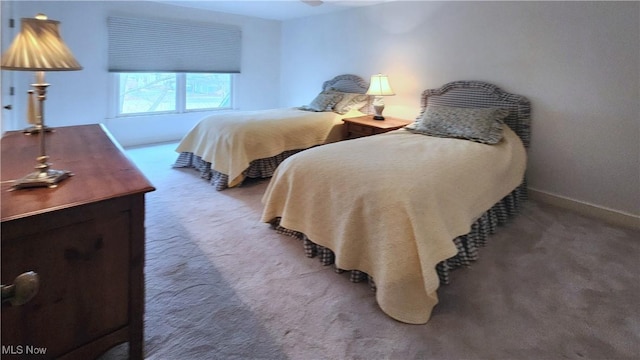 bedroom with baseboards and carpet