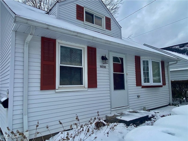 view of snow covered property entrance