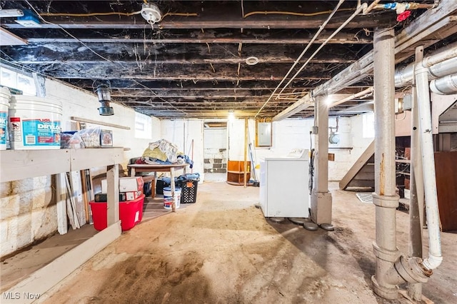 basement featuring electric panel and washer / clothes dryer