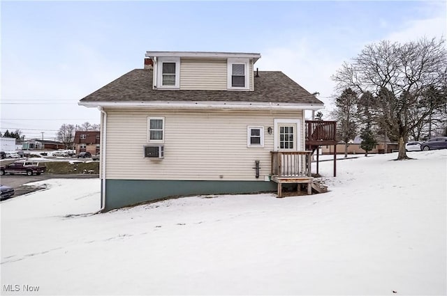 snow covered property featuring a wooden deck