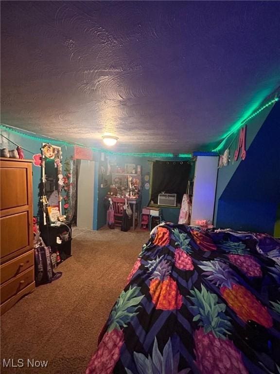 bedroom featuring a textured ceiling and carpet floors