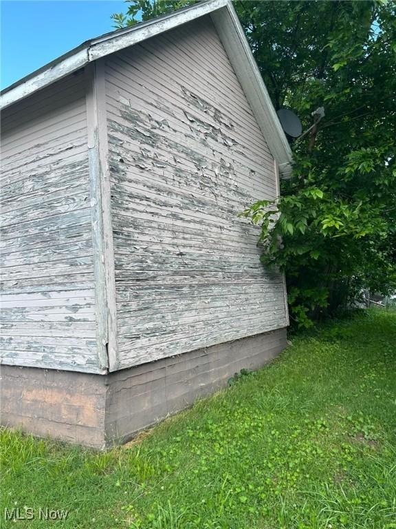 view of side of home featuring a yard