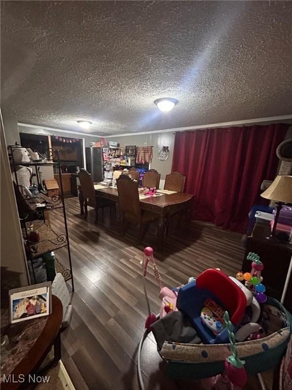 interior space with a textured ceiling and hardwood / wood-style flooring