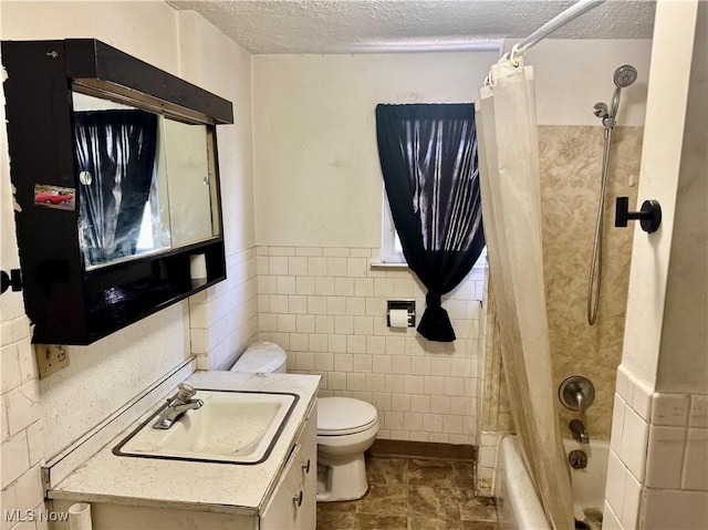 full bathroom featuring toilet, tile walls, shower / tub combo with curtain, and a textured ceiling