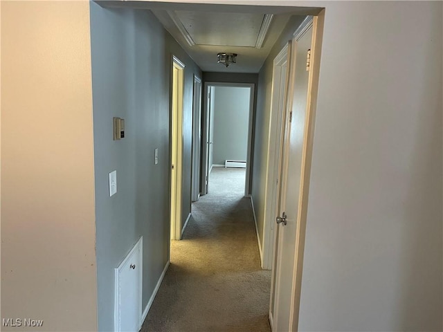 hallway featuring baseboard heating and dark carpet