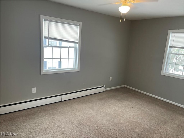 carpeted spare room featuring ceiling fan and a baseboard radiator