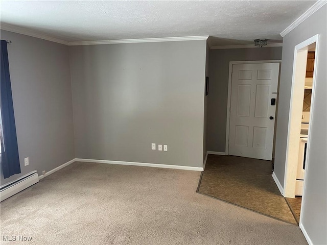 spare room with baseboard heating, carpet, crown molding, and a textured ceiling