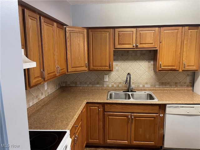 kitchen with decorative backsplash, exhaust hood, sink, and white appliances