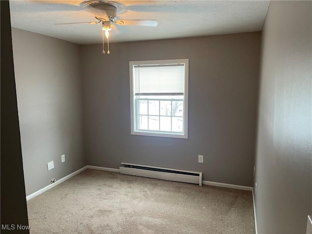 carpeted empty room featuring ceiling fan and a baseboard radiator