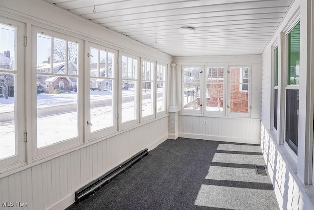 unfurnished sunroom featuring a baseboard heating unit