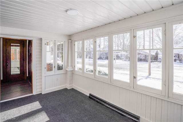 unfurnished sunroom featuring baseboard heating and a wealth of natural light