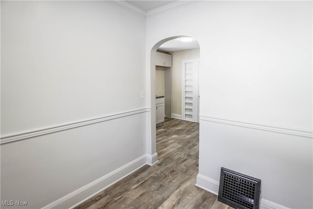 hallway featuring hardwood / wood-style flooring and crown molding