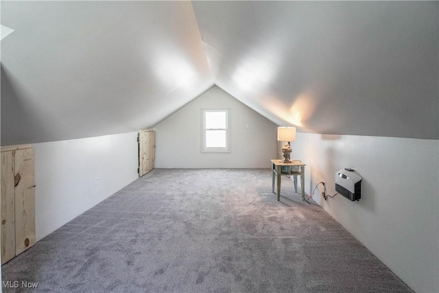 bonus room with lofted ceiling and carpet floors