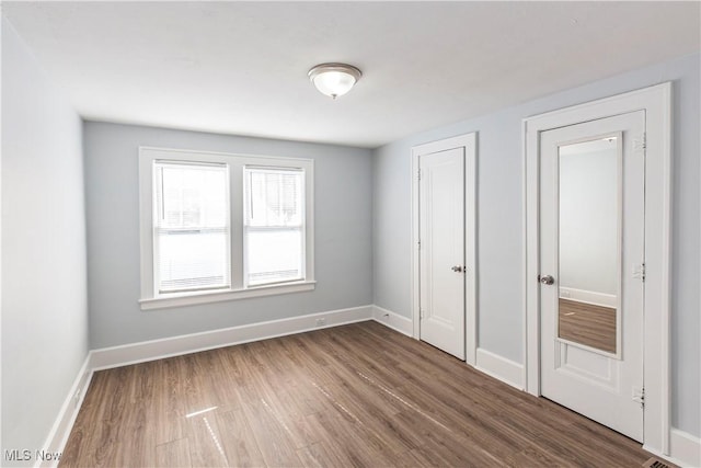 unfurnished bedroom featuring wood-type flooring