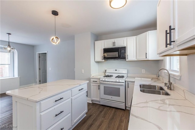 kitchen with white range with gas stovetop, pendant lighting, white cabinets, and sink