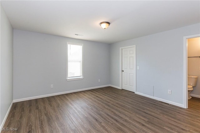 empty room featuring dark hardwood / wood-style flooring