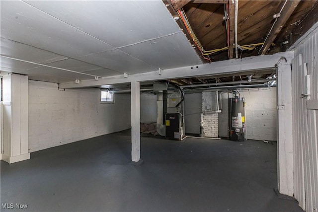 basement featuring water heater and heating unit