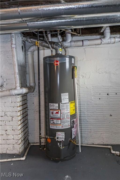 utility room featuring water heater