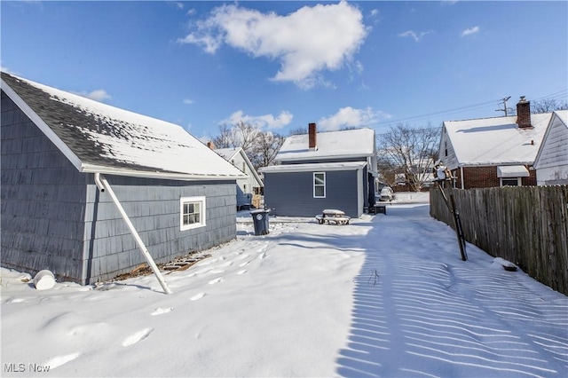 snowy yard featuring an outdoor structure