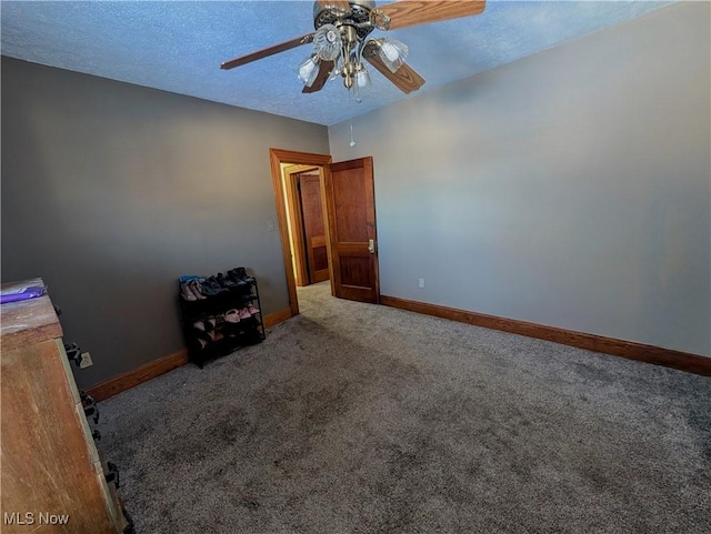 spare room featuring carpet floors, a textured ceiling, and ceiling fan