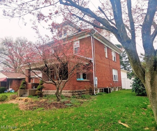 914 27th St, Parkersburg, WV 26104 - view of home's exterior featuring fence, brick siding, and a yard