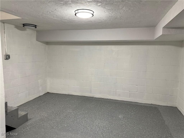 basement featuring a textured ceiling