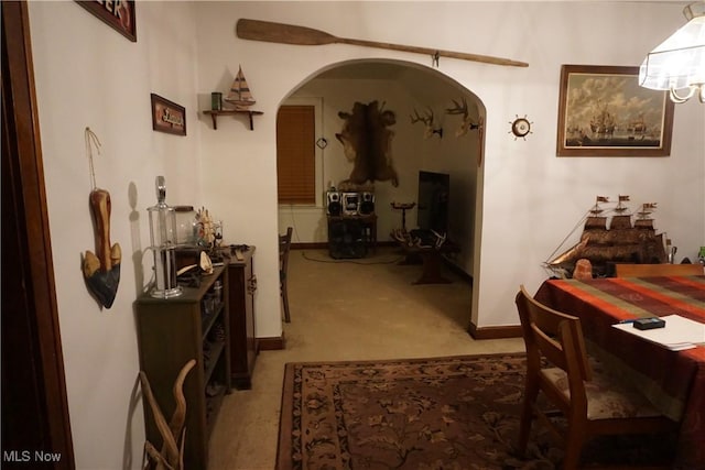 hallway featuring light colored carpet