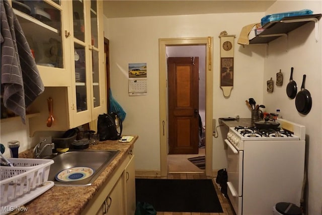 kitchen featuring sink and white gas range oven