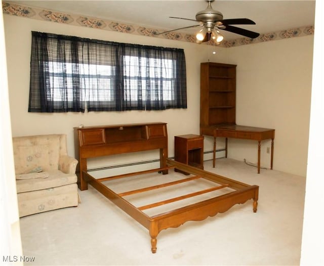 carpeted bedroom featuring baseboard heating and ceiling fan