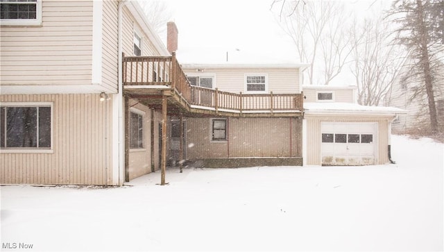 snow covered property featuring a balcony