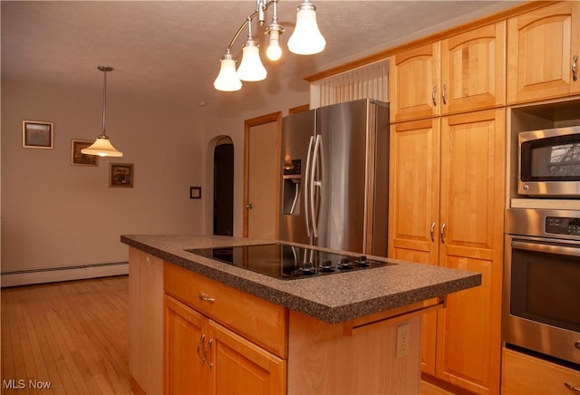 kitchen featuring light wood-type flooring, baseboard heating, appliances with stainless steel finishes, a kitchen island, and pendant lighting