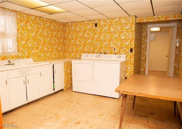 laundry room featuring cabinets, sink, and washer and dryer