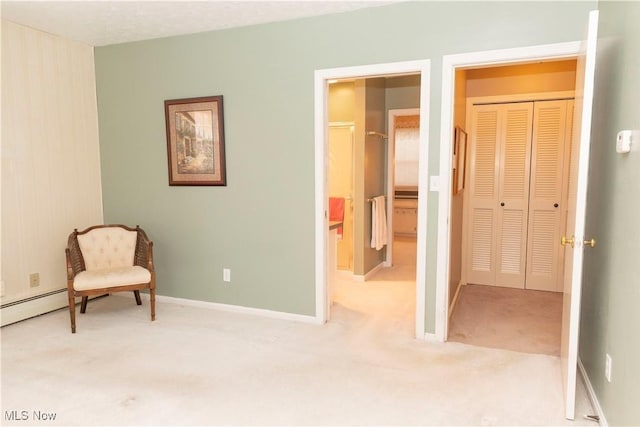 sitting room featuring light colored carpet