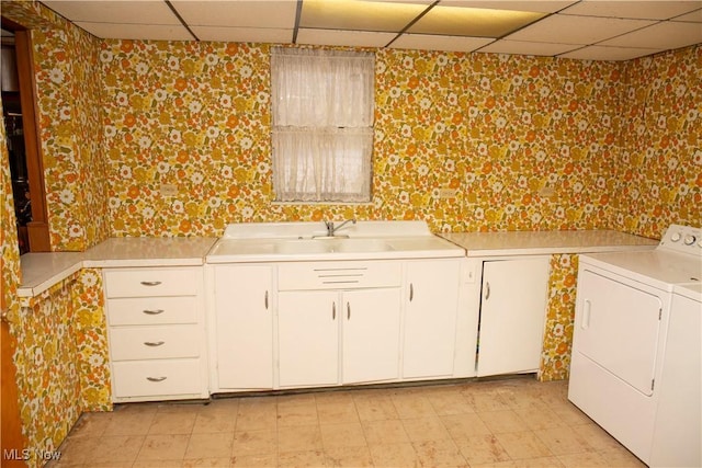 laundry area featuring cabinets, sink, and washing machine and dryer