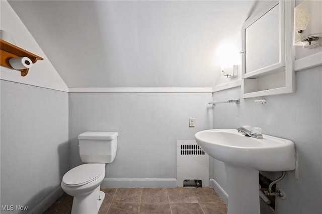 bathroom featuring radiator, toilet, and lofted ceiling