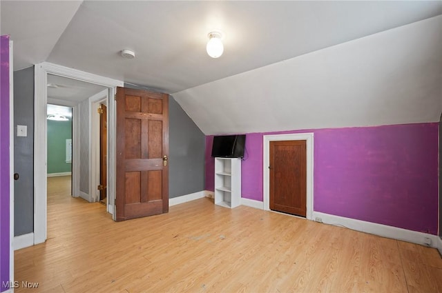 bonus room featuring vaulted ceiling and light hardwood / wood-style flooring