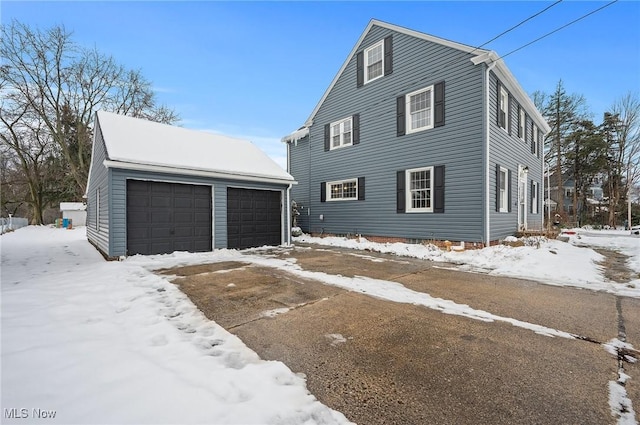 view of front of property with a garage and an outbuilding