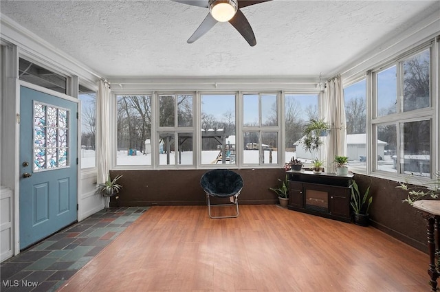 sunroom / solarium with ceiling fan