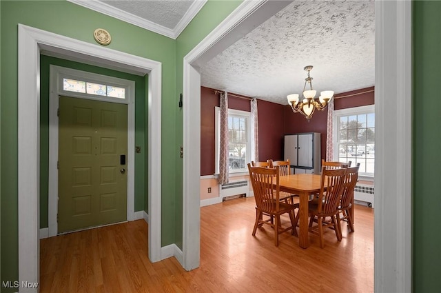 dining area with plenty of natural light, radiator heating unit, and a textured ceiling